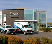 Image captures the Stinson corporate head office with two trucks in the foreground